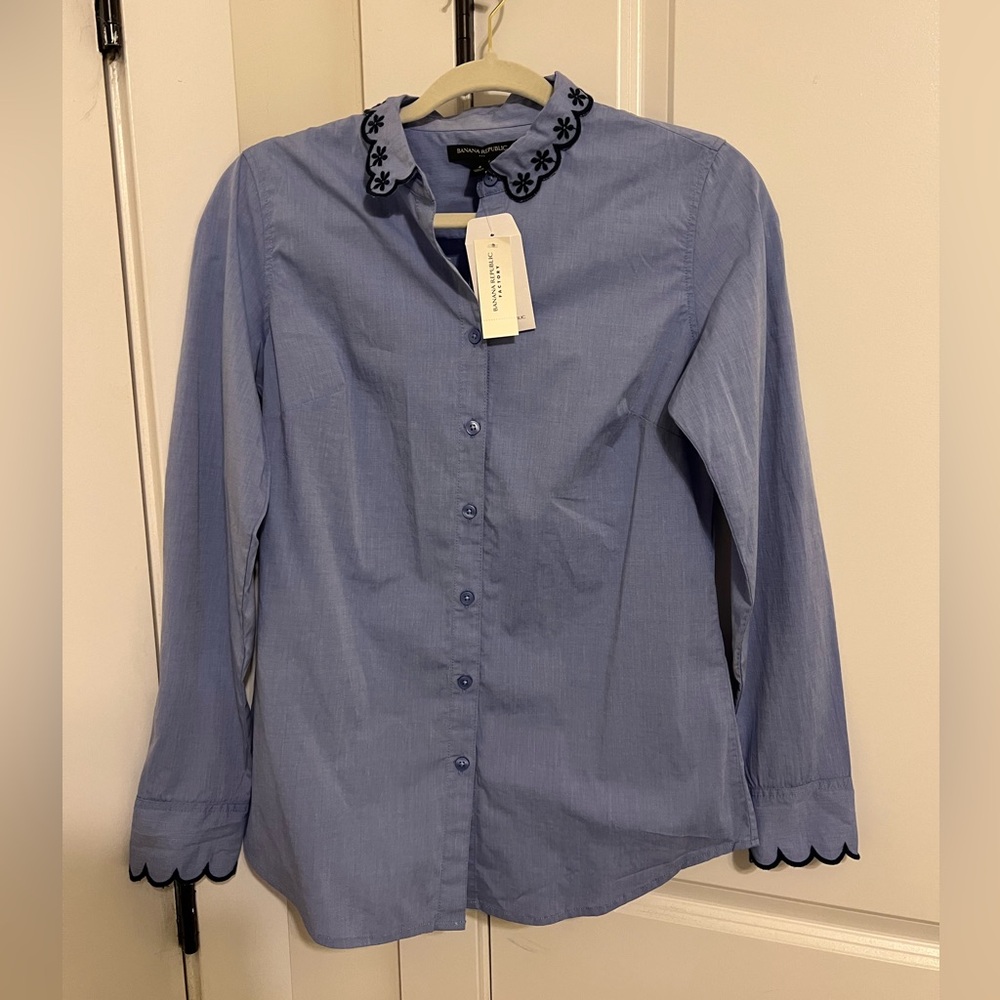 Blue collard shirt with dark scallop/flower trim detailing